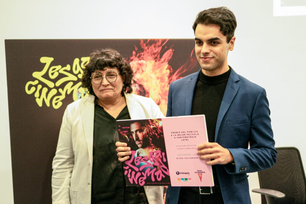 En la imagen, Ana Pérez, Presidenta de la Asociación Cultural Ideocon y fundadora de PhotoRivas, entrega el premio del cortometraje ganador 'Divercity' recogido por Rodrigo Paniagua. 